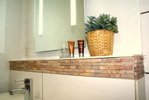 a brick shelf with glasses and a potted plant on it at Pension Lindenhof in Limburg an der Lahn