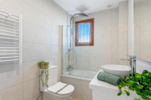 a bathroom with a toilet and a sink and a tub at Villa K9 Ortenbach in Ifach