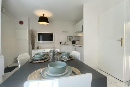 une salle à manger avec une table et des chaises dans une cuisine dans l'établissement Maison 4 personnes avec jardin et parking, au Crotoy