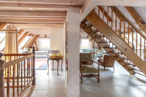 a staircase in a house with a living room at Boutique-Hotel Guesthouse Le Locle in Le Locle