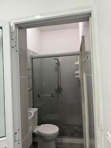 a bathroom with a toilet and a glass shower at Crush of the year in Dakar