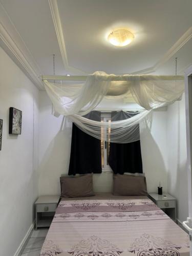 a bedroom with a large bed with a window at Crush of the year in Dakar