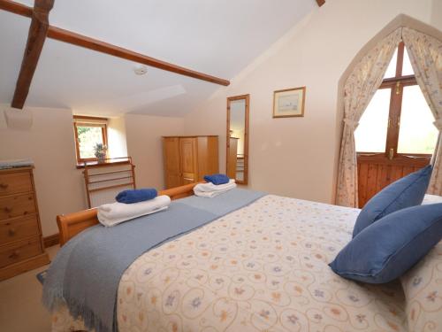 a bedroom with a large bed with blue pillows at 2 Bed in Glastonbury THEOL in Stawell