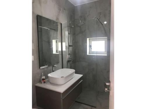 a bathroom with a sink and a shower at Villa Avra in Ierápetra