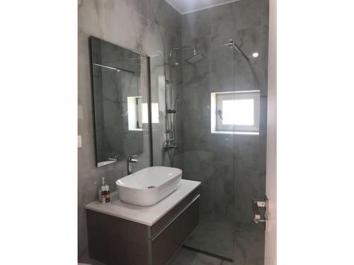 a bathroom with a sink and a shower at Villa Avra in Ierapetra