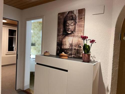a painting of a bust of a woman on a wall at Chalet Maithili Lauterbrunnen -152-Year-Old Majestic Chalet in Lauterbrunnen