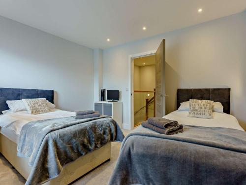 a bedroom with two beds and a television at 2 Bed in Sandown 89291 in Sandown