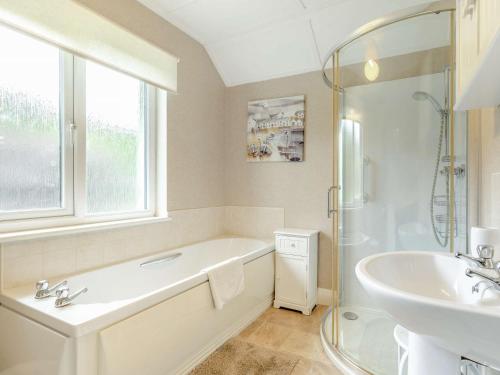 a bathroom with a tub and a sink and a shower at 2 Bed in Kielder 89299 in Falstone