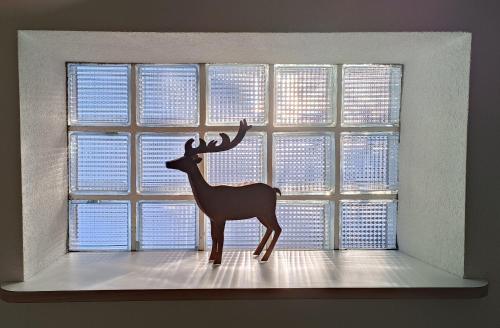 a statue of a deer in a window at Chalet M in Davos