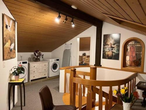 a living room with a kitchen with a microwave at Chalet Maithili Lauterbrunnen -152-Year-Old Majestic Chalet in Lauterbrunnen