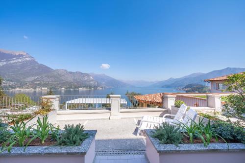 a patio with a view of the water and mountains at Borgo Le Terrazze in Bellagio