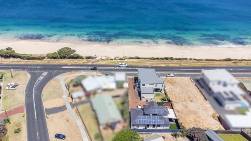 an aerial view of a road and the ocean at Hollow Beach House - Bunbury in Bunbury