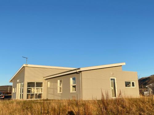 a house in the middle of a field at Guesthouse Eldhestar in Hveragerði