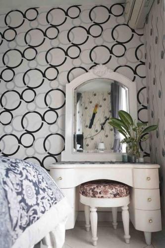 a bedroom with a mirror and a white dressing table at The Sangtus Home in Babakan Madang