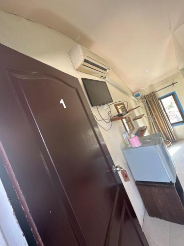an rv with a black refrigerator and a tv at Lonely beach complex titanic hotel in beach shopping street markets ในศูนการค้าติดทะเล in Khlaung Phai Bae