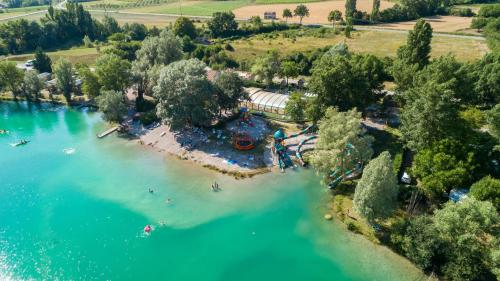 an aerial view of a lake with people swimming in it at Camping Le Lac Bleu in Châtillon-en-Diois