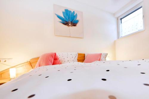 a bedroom with a bed with a blue flower painting on the wall at Chalet Keßler in Tschagguns