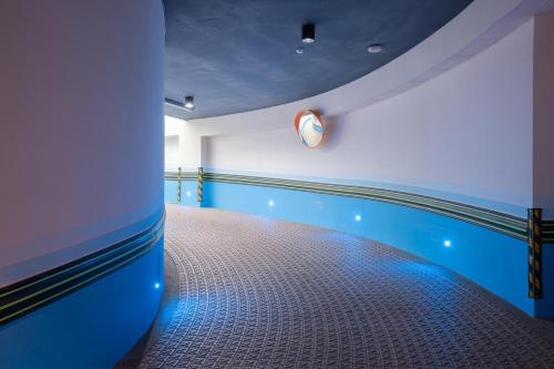 a room with a swimming pool with a clock on the wall at Guide Hotel Taichung Ziyou in Taichung