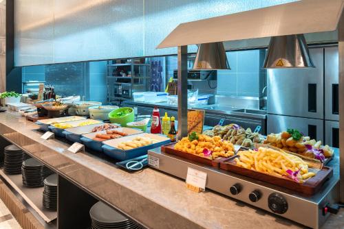a buffet line with many different types of food at SSAW Boutique Hotel Shanghai Bund in Shanghai