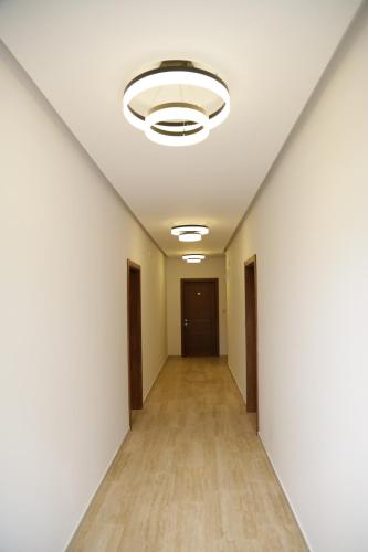 an empty corridor in an office building with a ceiling at Hotel Comfort & Villas in Donji Štoj