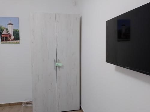 a white cabinet with a tv on top of it at Apartman Dve lipe in Palić