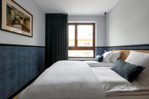 a bedroom with two beds and a window at Homewell Apartments Czartoria- free parking in Poznań