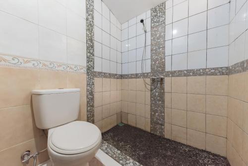 a bathroom with a toilet and a shower at Urbanview Resort Anty Cisarua Tugu Puncak by RedDoorz in Sampal 2