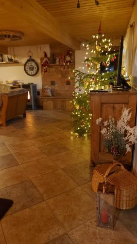 a living room with a christmas tree in a room at Apartamenti Dundaga XXL in Dundaga