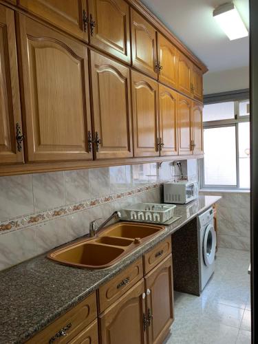 a kitchen with a sink and a washing machine at K House in Odivelas