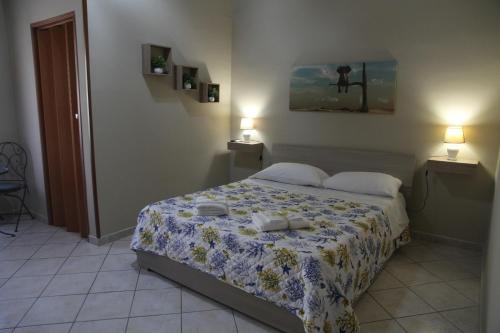 a bedroom with a bed and two lamps on the wall at Il Principe di Napoli in Benevento