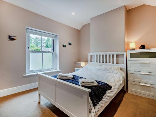 a bedroom with a white bed and a window at 3 Bed in Bamford PK838 in Bamford