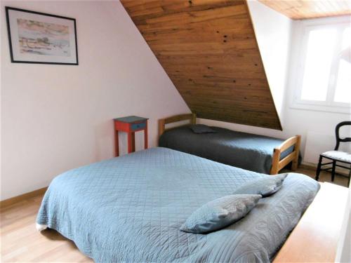 une chambre avec un lit dans un grenier dans l'établissement Maison 5 pièces 8 à 9 personnes avec jardin à 50 m de la plage - AVEL, à Sarzeau