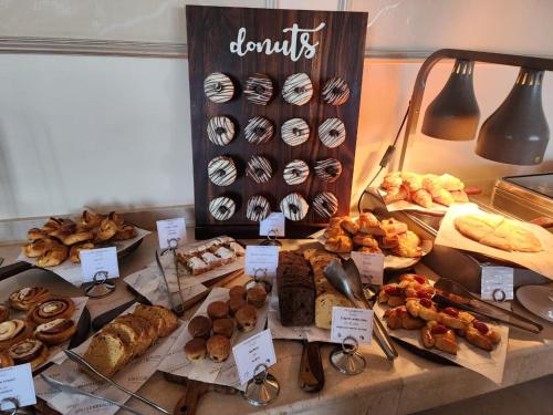 a table with many different types of pastries and desserts at Steigenberger Cecil Hotel Alexandria in Alexandria
