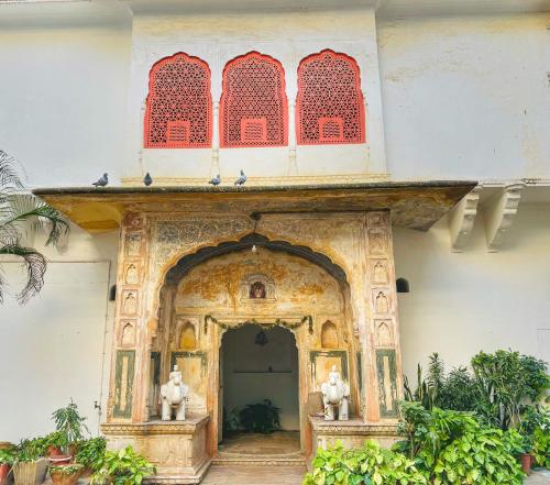 an entrance to a building with red and white at Saba Haveli in Jaipur