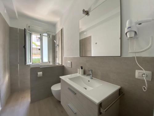 a bathroom with a white sink and a toilet at Casa Antonio - apartamento Luna in Playa de San Juan