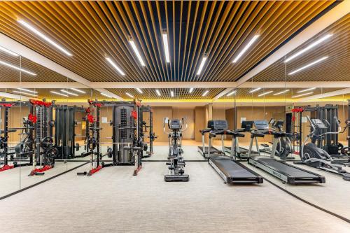 a gym with a lot of treadmills and machines at Holiday Inn Express Suzhou Bay by IHG in Suzhou