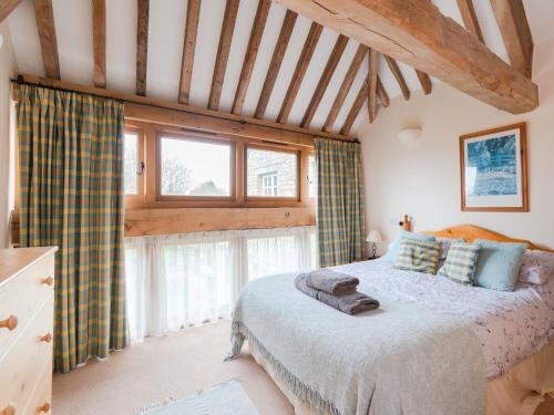 a bedroom with a bed and a large window at 6 Bed in Woodstock CC028 in Stonesfield