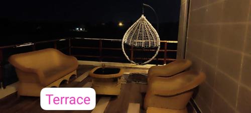 a balcony with two chairs and a net at Vedic village aqua villa 3bhk in kolkata