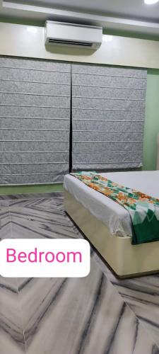 a bedroom with a bed and a window at Vedic village aqua villa 3bhk in kolkata