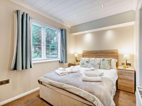 a bedroom with a bed with towels on it at 1 Bed in Coniston Water 50081 in High Nibthwaite
