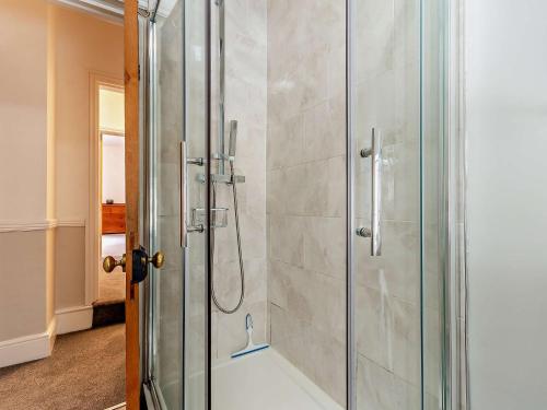 a shower with a glass door in a bathroom at 4 bed in Cromford 52094 in Highpeak Junction