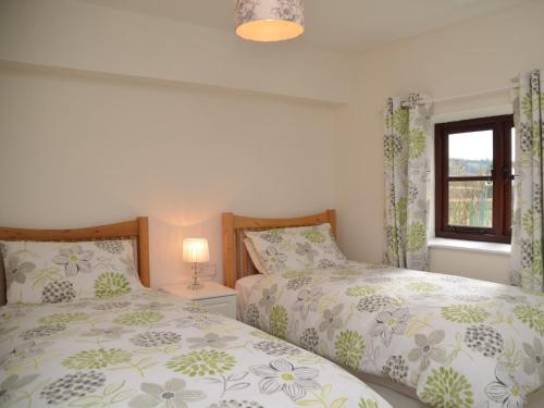 a bedroom with two beds and a window at 2 Bed in Bath 56550 in Stowey