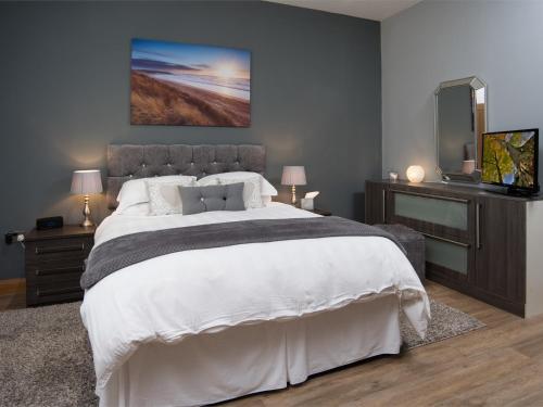 a bedroom with a large bed and a flat screen tv at 1 bed property in Durham CN208 in Lanchester