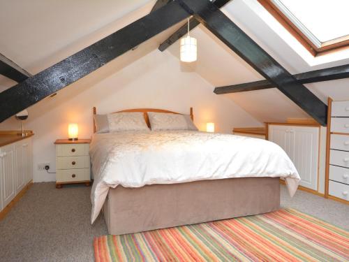 a bedroom with a large bed in a attic at 1 Bed in Porthgain 61170 in Porthgain