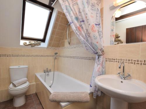 a bathroom with a tub and a sink and a toilet at 2 bed property in Shanklin Isle of Wight IC059 in Shanklin