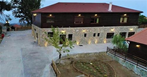 a large building with a tree in front of it at EVIA FOREST VILLAGE in Pappádhes