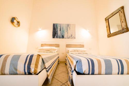 A bed or beds in a room at Mare e Castello