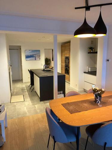 a dining room and kitchen with a table and chairs at Spacious Apartment With Sea View in Ostend