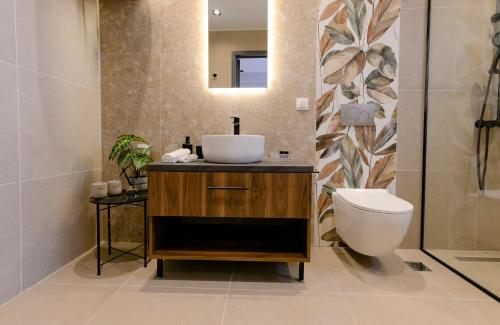 a bathroom with a sink and a toilet at Luxury Super Central Apartment 2 in Larisa