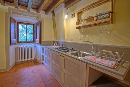 a kitchen with a sink and a counter top at Montegufoni by PosarelliVillas in Montagnana Val di Pesa